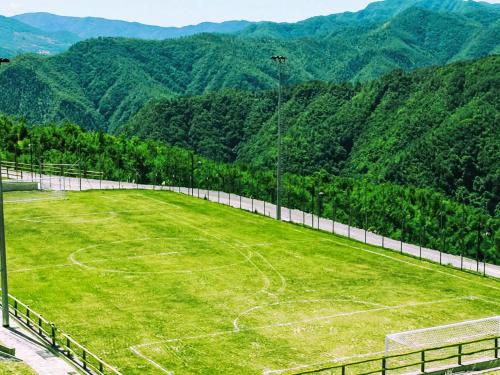 an empty soccer field with mountains in the background at Apartment Cancelli bilo 2 persone by Interhome in Palazzuolo sul Senio