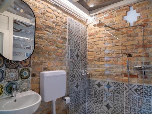 a bathroom with a toilet and a sink and a mirror at Villa Mike's Dinghy House by Interhome in Citta' Sant'Angelo