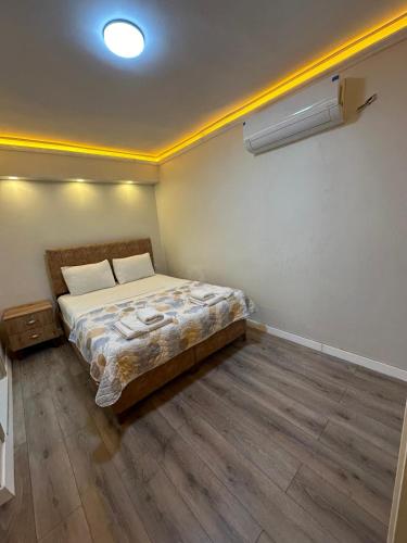 a bedroom with a bed in the corner of a room at pilot hotel 2 in Tayakadın