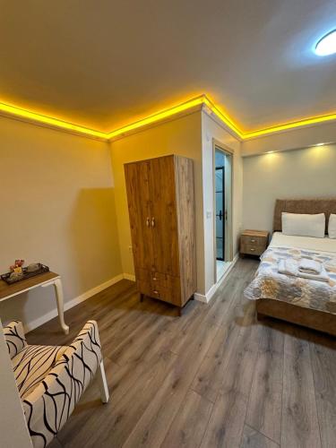 a bedroom with a bed and a wooden floor at pilot hotel 2 in Tayakadın