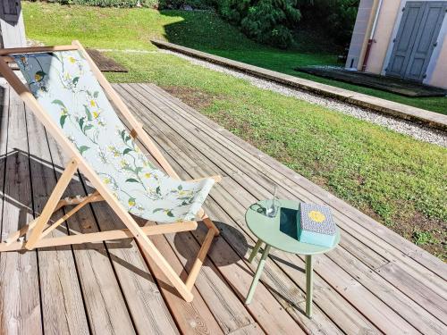 une chaise et un livre assis sur une terrasse dans l'établissement Apartment Conseil-9 by Interhome, à Saint-Gervais-les-Bains