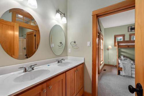 a bathroom with two sinks and a mirror at VOH151 FINALLY in Corolla
