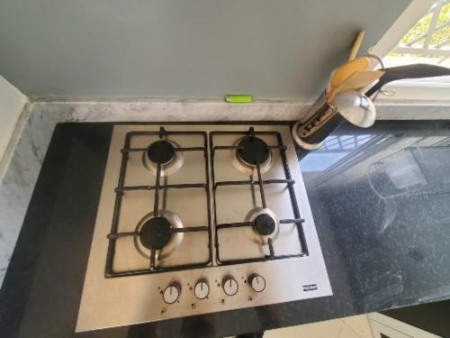 a stove top with four burners on top of it at Spacieux Appartement in Marrakech