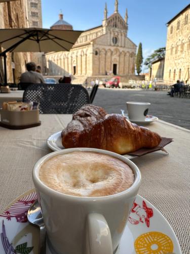 a cup of coffee and a pastry on a table at Il cuore in Toscana in Massa Marittima