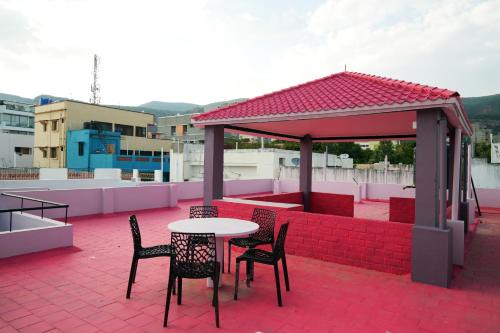 a patio with a table and chairs on a roof at Hill View Paradise - A luxurious 2bhk's & Private Rooms Near Bhudevi Complex TTD Ticket Counter Alipiri in Tirupati
