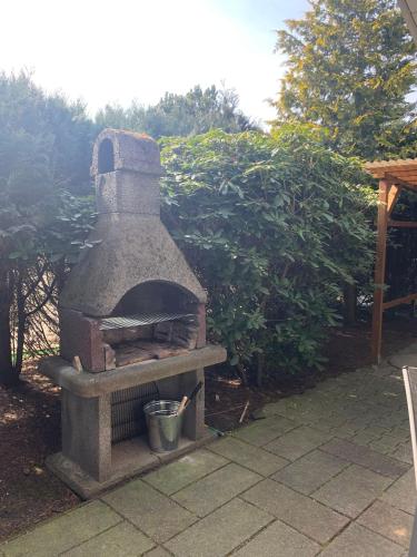 a stone oven sitting on top of a patio at Gepflegtes-Ferienhaus-am-Dankernsee-Haren-Emsland in Haren