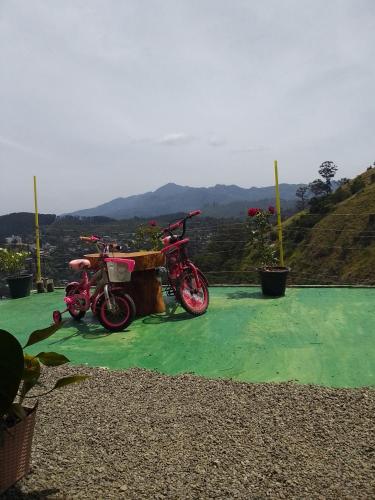 two motorcycles parked next to each other on top of a hill at Ella Black Bridge View Cottage Sri Lanka in Ella