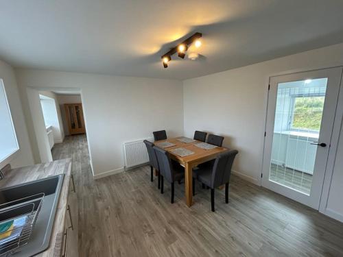 a dining room with a table and chairs at Modern 3 bedroom house, Mossbank in Mossbank