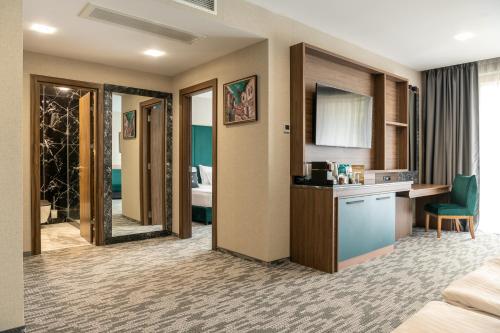 a hotel room with a bed and a bathroom at Santé SPA Hotel in Velingrad