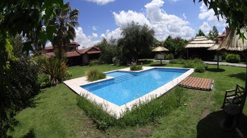 a swimming pool in the yard of a house at Guesthouse El Tata in Vistalba