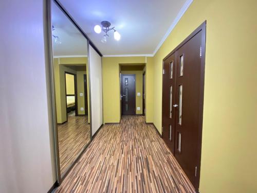 a hallway with two doors and a mirror at Комната in Chişinău