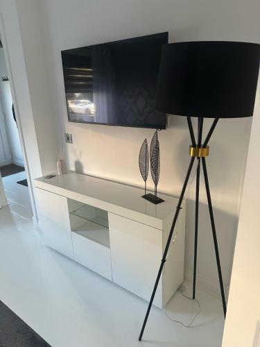 a desk with a black lamp in a room at Black Daisy in Glasgow