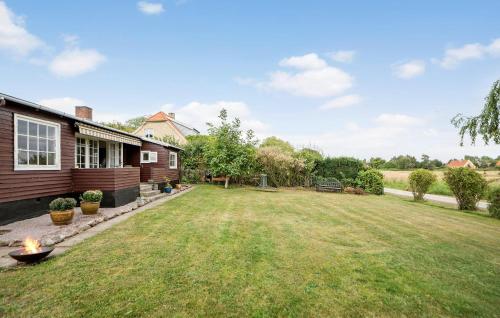 a backyard of a house with a grass yard at 2 Bedroom Beach Front Home In Rude in Rude