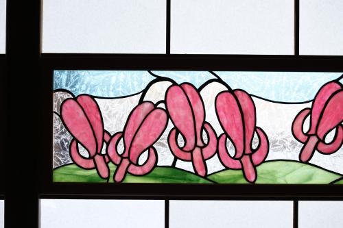 a stained glass window with pink flowers at Tsuyukusa in Takayama
