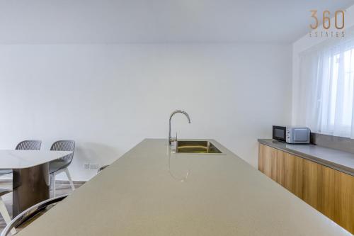a kitchen with a sink and a counter top at The St Pauls Bay Escape Suites by 360 Estates in St Paul's Bay