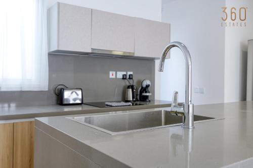 a kitchen with a sink and a counter top at The St Pauls Bay Escape Suites by 360 Estates in St Paul's Bay