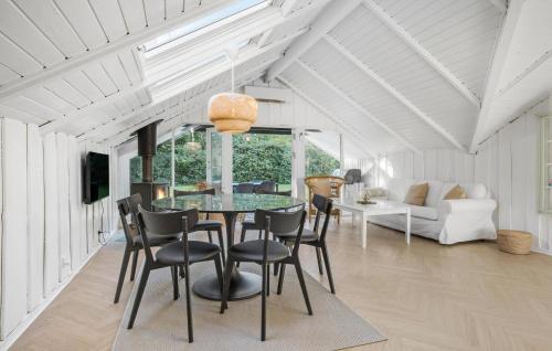 a dining room with a glass table and chairs at 4 Bedroom Stunning Home In Tisvildeleje in Tisvildeleje