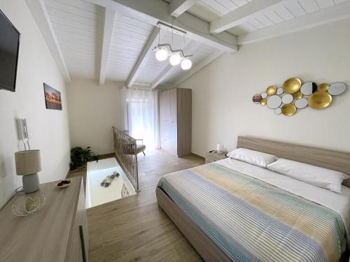 a bedroom with a bed and a television in it at La Casa di Ginevra in Lamezia Terme