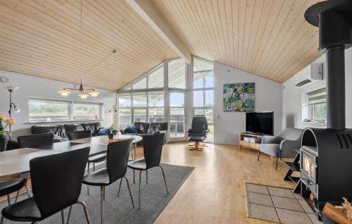a living room with a table and chairs at Awesome Home In Hemmet With Sauna in Hemmet