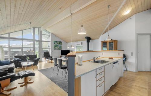 a kitchen and living room with a table and chairs at Awesome Home In Hemmet With Sauna in Hemmet