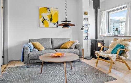 a living room with a couch and a table at 2 Bedroom Amazing Home In Svaneke in Svaneke
