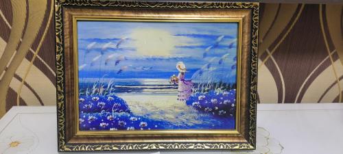a painting of a woman in a field of flowers at 鸢尾之家 in Harbin
