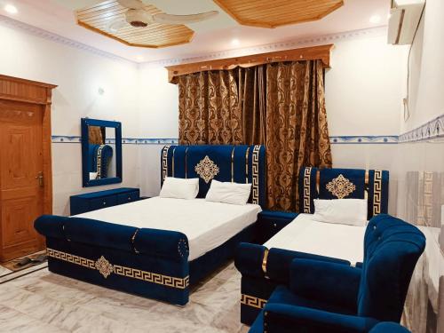 a bedroom with two beds and a couch at Istanbul Inn in Islamabad