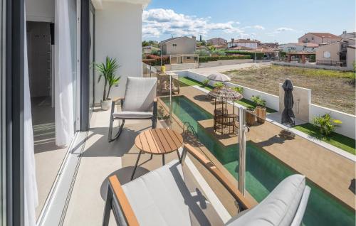 a balcony with a view of a swimming pool at Nice Home In Vrvari With Wifi in Poreč