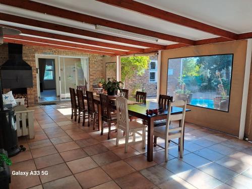 a dining room with a table and chairs at The Golden Grape B&B in Lutzville