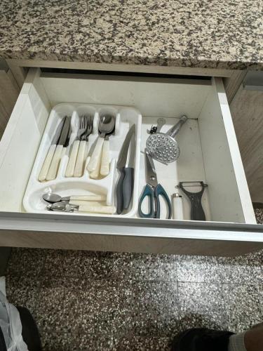 a drawer full of kitchen utensils in a cabinet at Departamento en junin in Junín