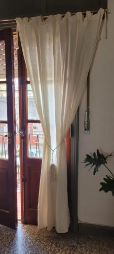 a curtain is hanging in front of a door at Departamento en junin in Junín