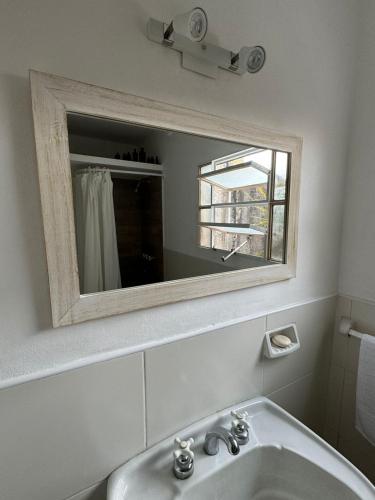 a bathroom with a sink and a mirror at Departamento en junin in Junín