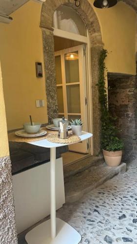 a table with dishes on it in a building at Casa Melox in Lezzeno