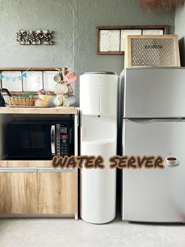 a kitchen with two refrigerators and a microwave at JaM in Noboribetsu
