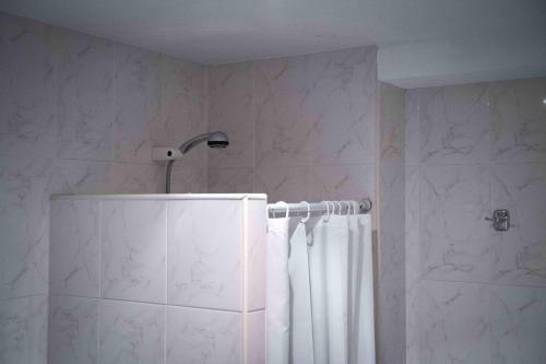 a bathroom with a shower with a shower curtain at Agroturismo Biltegi Etxea in Alda