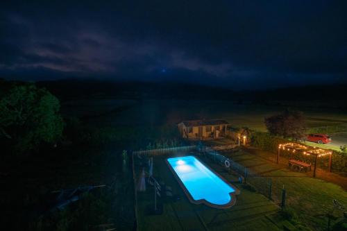 an overhead view of a swimming pool at night at Agroturismo Biltegi Etxea in Alda
