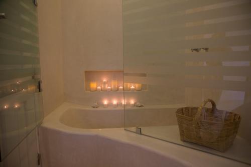 a bathroom with a tub with candles in it at LiveTulum in Tulum