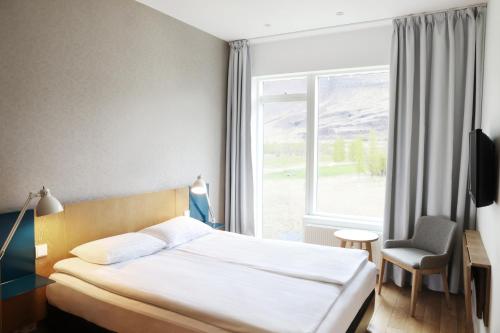 Postel nebo postele na pokoji v ubytování Fosshotel Vatnajökull