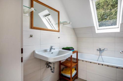 a bathroom with a sink and a bath tub at Haus Sonnenschein in Pahlen