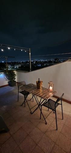 a table and chairs on a patio at night at Casa40 Attico con terrazza in Rome