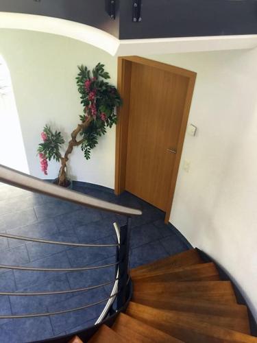 a staircase in a building with a door and a room at Villa with Pool - Leon's Holiday Homes in Dottikon