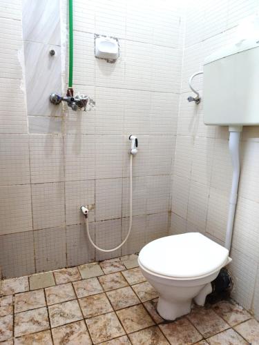 a bathroom with a toilet and a shower at HOMELAND SWAHILI LODGE Nungwi Backpacker Apartments BUDGET in Nungwi