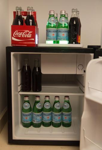 a refrigerator filled with lots of bottles of soda at LiveTulum in Tulum