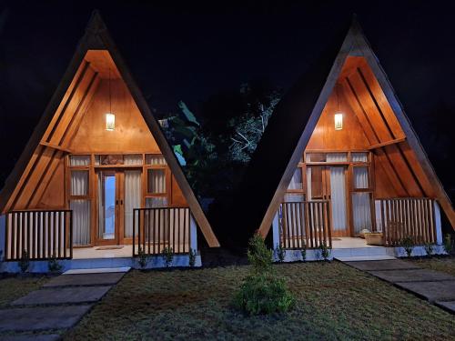 a house with two large windows in the night at D' Rinjani View Bungalow in Masbagik