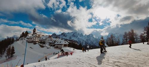 a group of people skiing down a snow covered mountain at Residence Soča in Soča