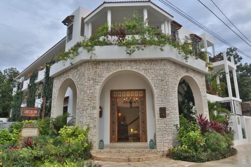 a building with a door and flowers on it at LiveTulum in Tulum