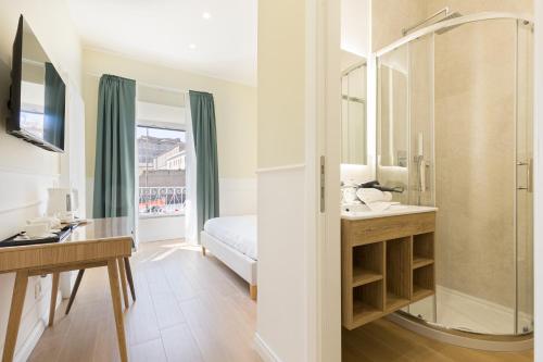 a bathroom with a shower and a sink and a mirror at Risorgimento 9 - Guest House in Rome