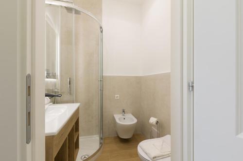 a bathroom with a sink and a toilet and a shower at Risorgimento 9 - Guest House in Rome