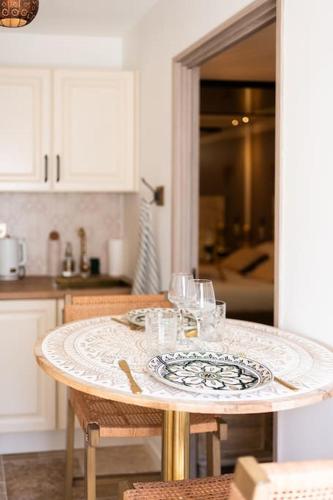 - une table dans une cuisine avec une assiette de verres à vin dans l'établissement Love Room 1001 nuits & Balnéo, à Saint-Rambert-dʼAlbon