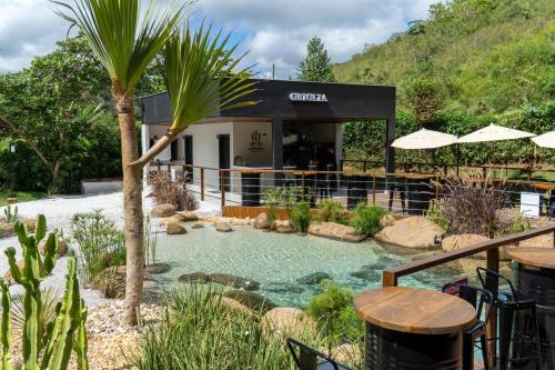 a pool with a palm tree in front of a restaurant at Villaggio Zamprogno in Santa Teresa